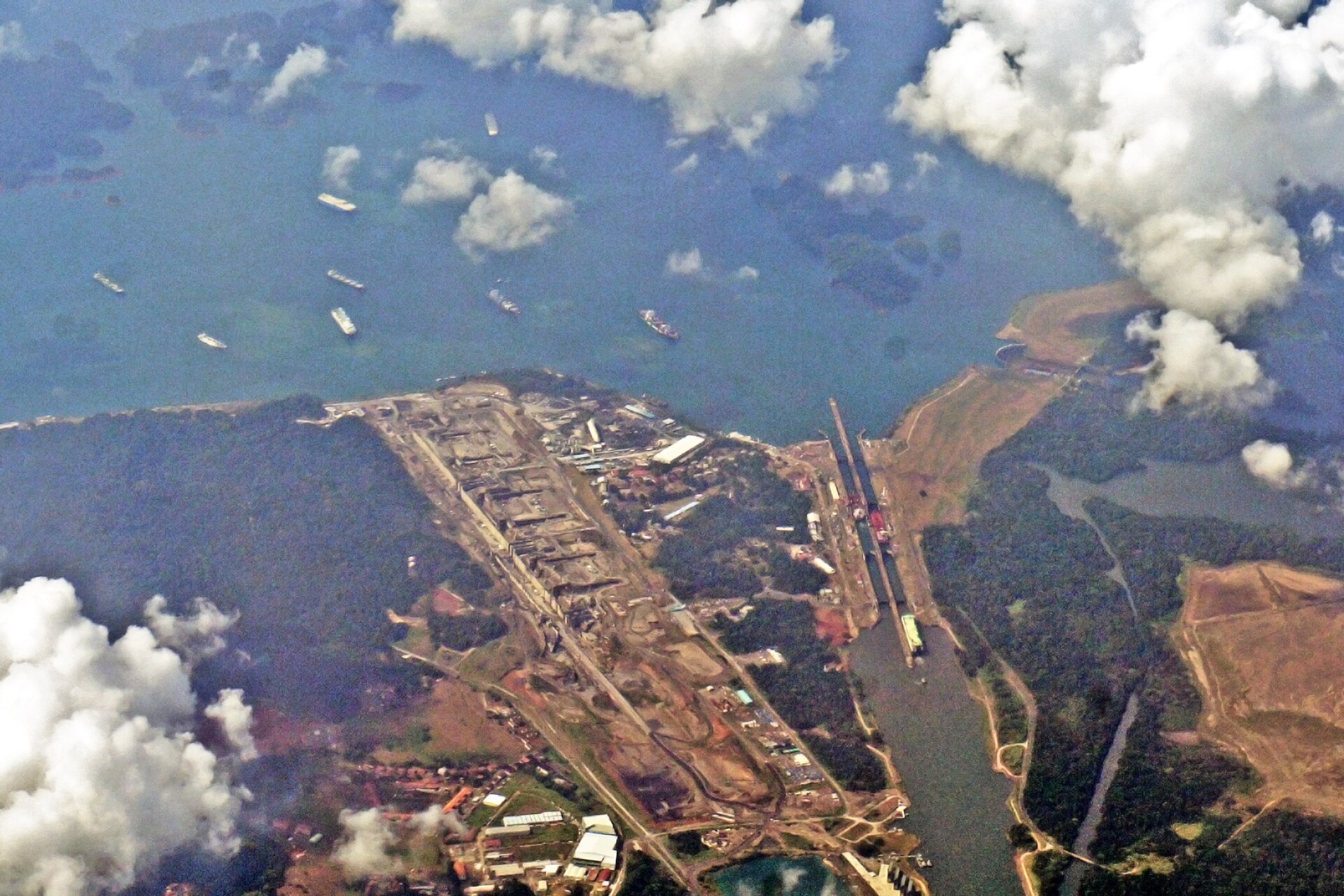 Aerial view of the Gatun Locks at the Panama Canal with vessels queuing to transit, showing the Atlantic side lock infrastructure