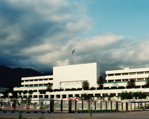 Pakistan Parliament House Islamabad daytime view with national flag