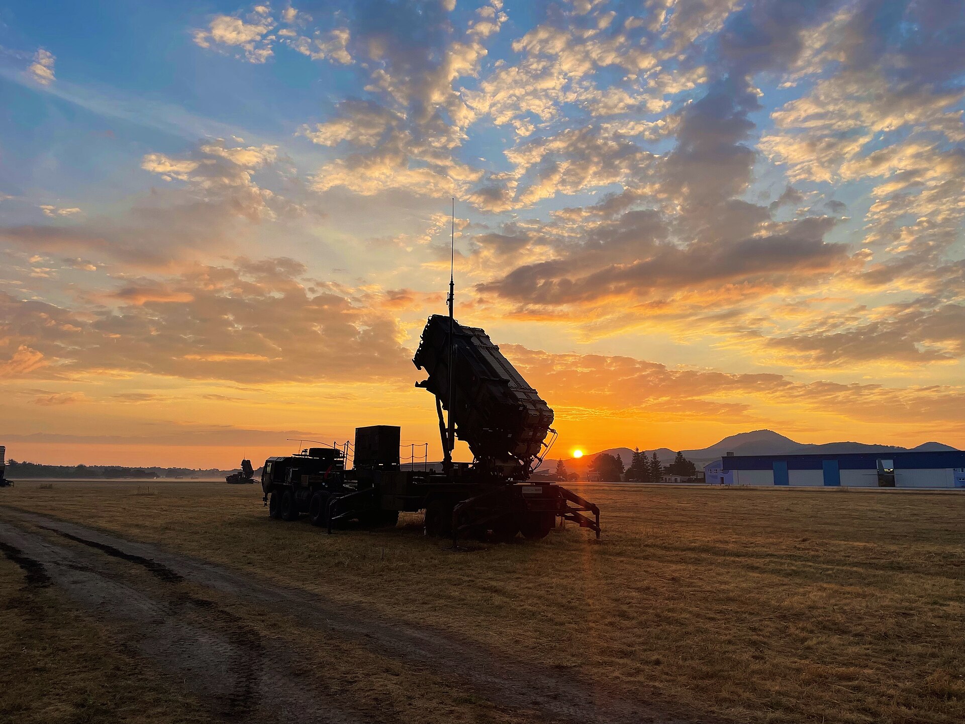 US Army Patriot PAC-3 missile launcher silhouetted at sunrise during NATO readiness exercises in Slovakia