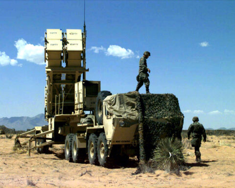 A Patriot PAC-3 missile launcher emplaced in desert terrain at Fort Bliss, Texas — identical to batteries now deployed around Mecca and Medina. Each launcher holds 16 interceptors at $3.9 million each; Saudi Arabia has consumed roughly 2,400 rounds in 38 days of war, leaving approximately 400 remaining. Photo: US Army / Public Domain
