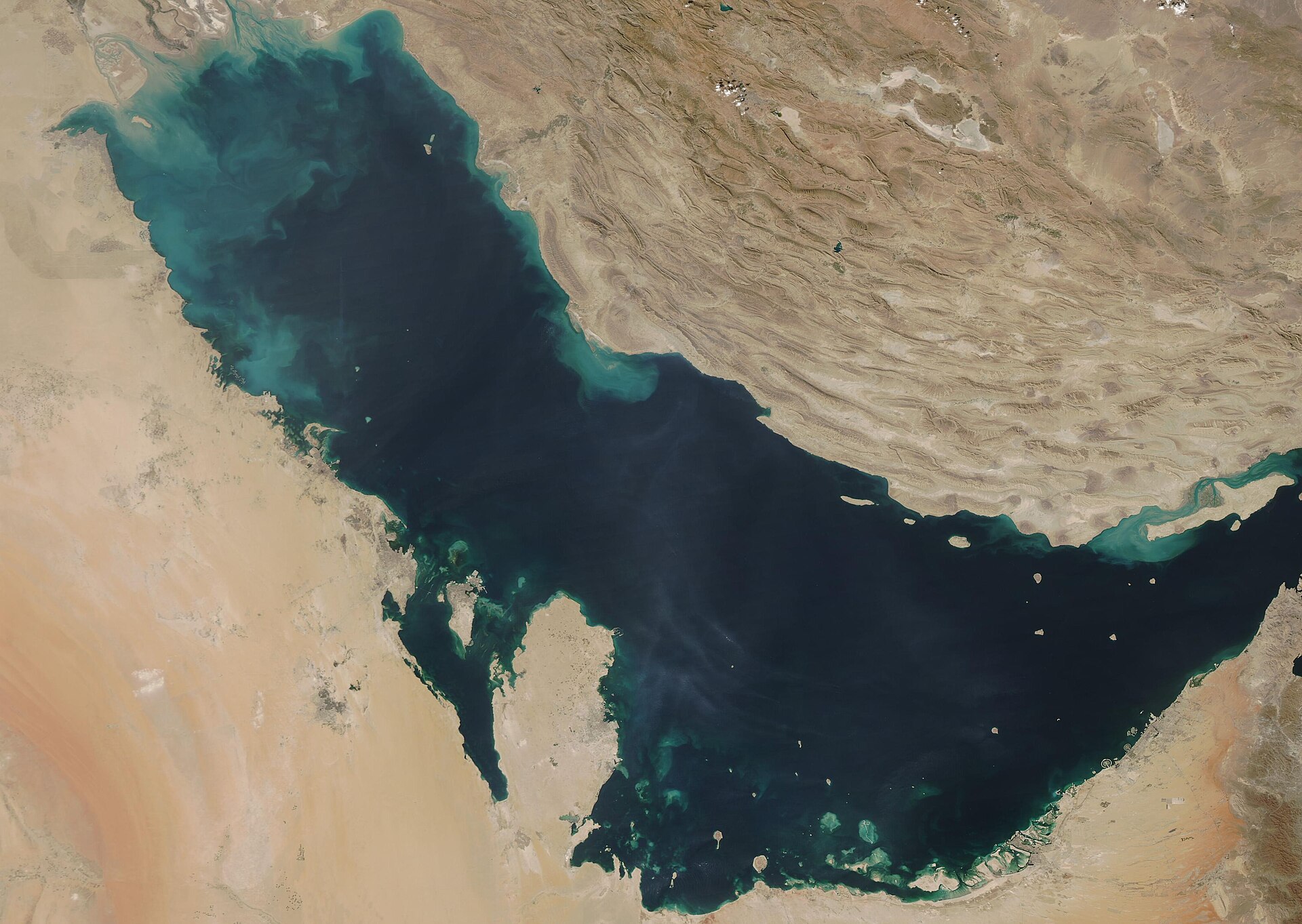 NASA MODIS satellite view of the Persian Gulf basin showing the full extent — Saudi Arabia western shore, Iran northeast coast, and all Gulf states within the IRGC declared targeting zone