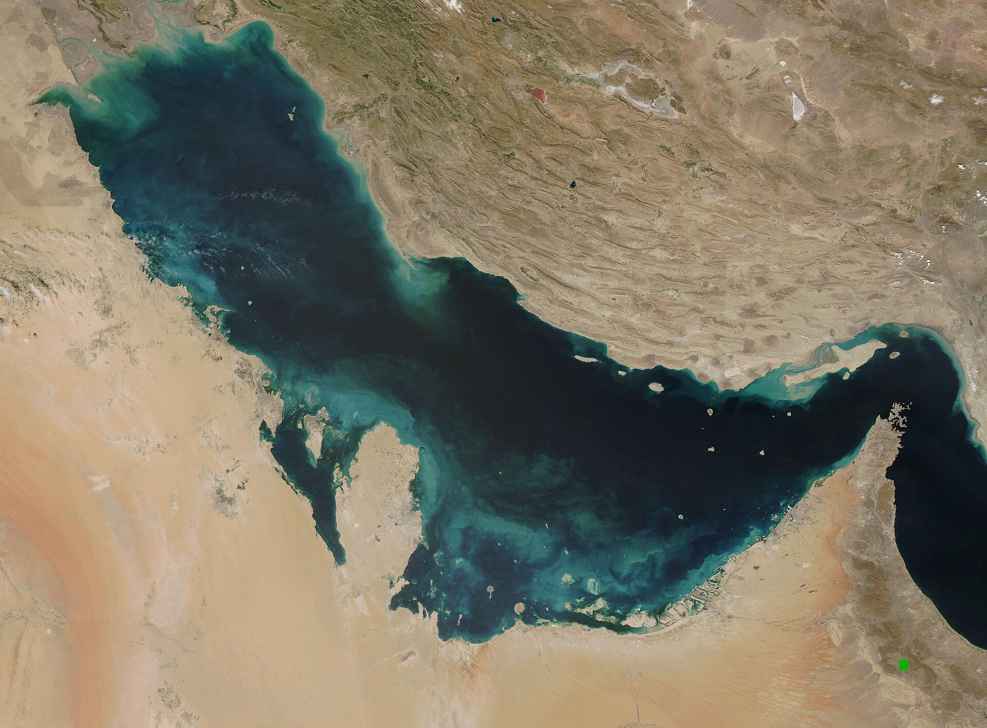The Persian Gulf and Strait of Hormuz, NASA MODIS satellite imagery March 2021 — the waterway through which 1.2 to 1.5 million Hajj pilgrims transit via Gulf ports, now running at approximately 3.6 percent of pre-war shipping throughput