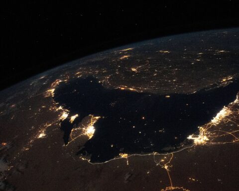 Persian Gulf at night from the International Space Station, showing lights of Bahrain, Iran, Iraq, Kuwait, Qatar, Saudi Arabia and the UAE surrounding the dark waters of the Gulf