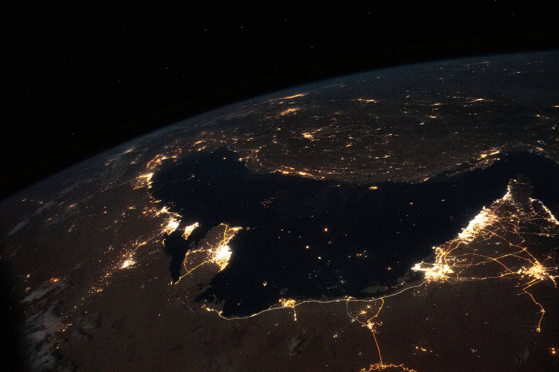 The Persian Gulf at night from the International Space Station — the concentrated lights of Bahrain, Kuwait, Qatar, Saudi Arabia and UAE mark the oil economy at the center of the Hormuz crisis