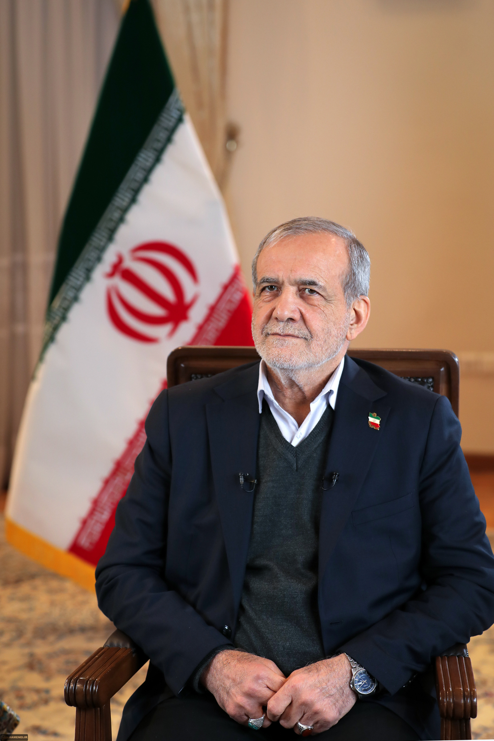 Iranian President Masoud Pezeshkian seated before Iranian flag, 2025, as IRGC overrides his authority