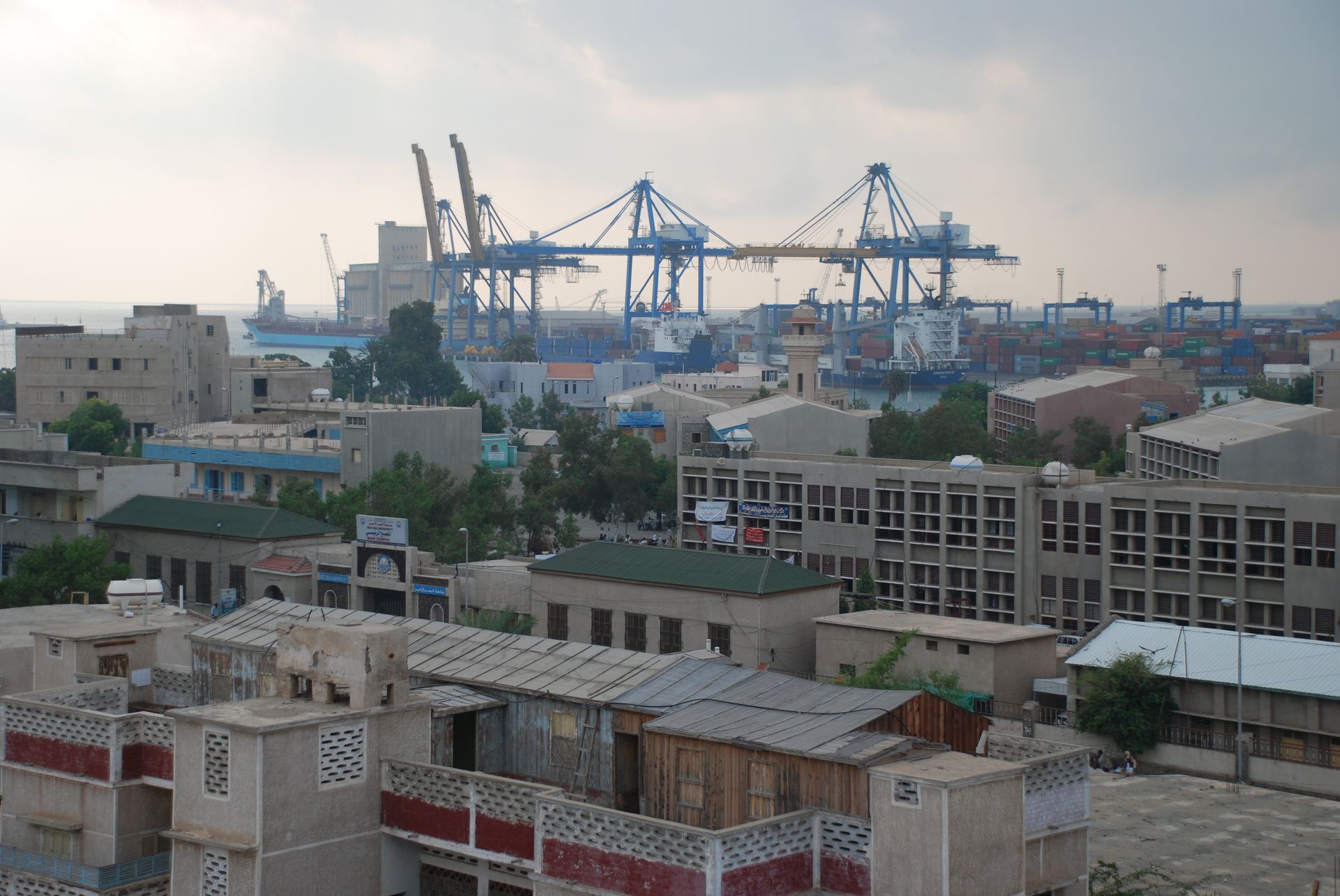 Port Sudan container terminal with ship-to-shore cranes on the Red Sea coast — Sudan's only major commercial port and the implicit prize in Saudi Arabia's strategic play