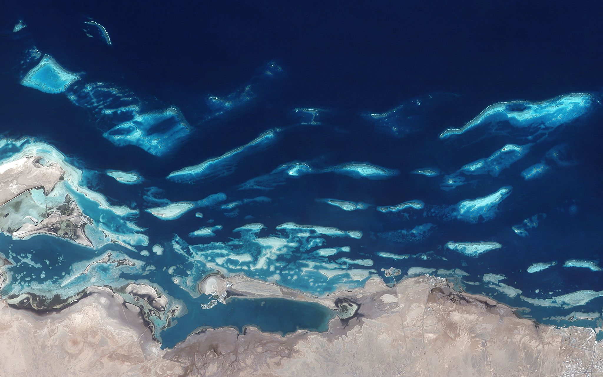Satellite view of the Red Sea coast of Saudi Arabia showing turquoise waters and coral reef islands where new golf courses are being built