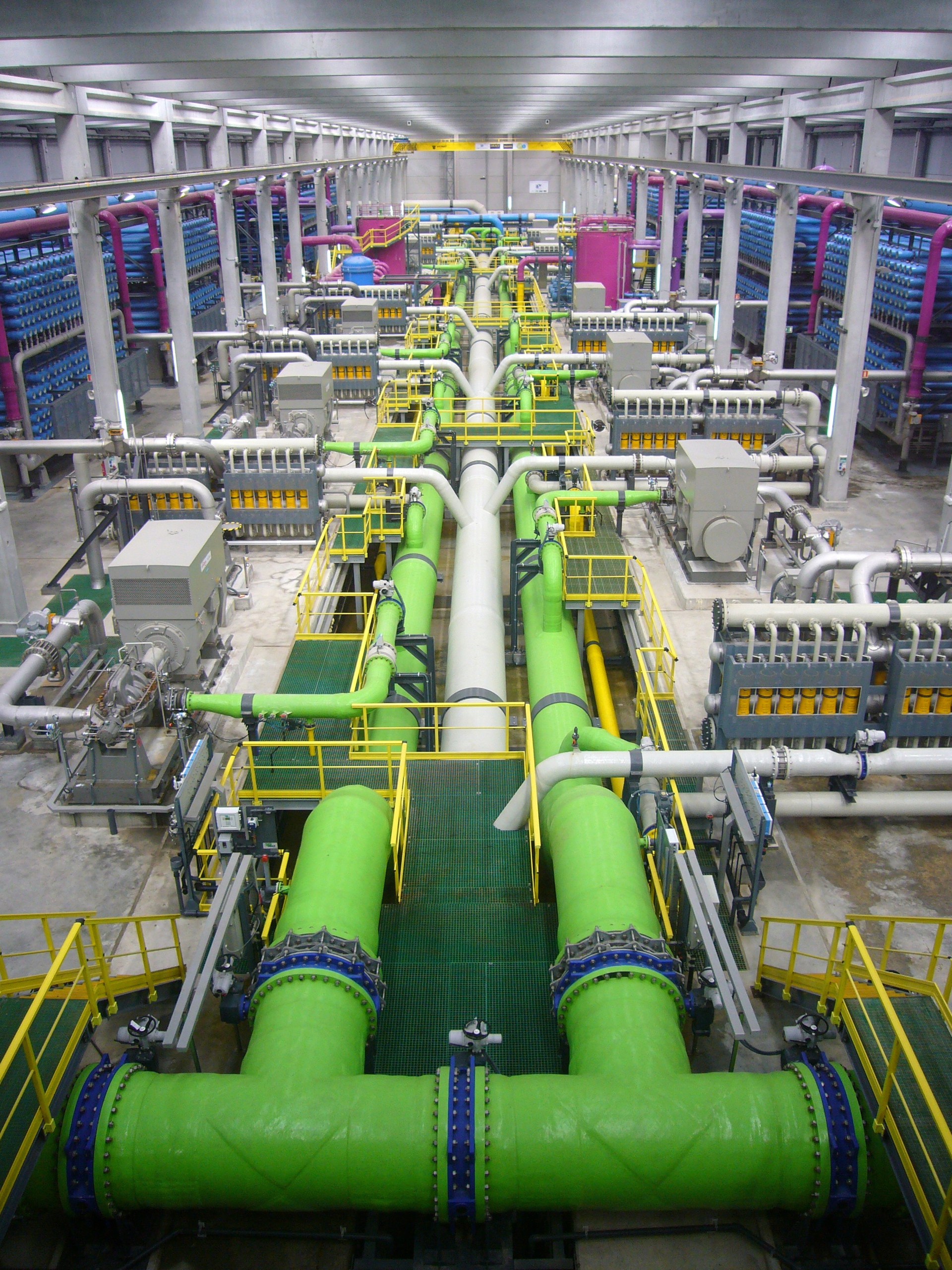Interior of a seawater reverse osmosis desalination plant showing high-pressure pipes and membrane filtration systems that convert seawater to drinking water