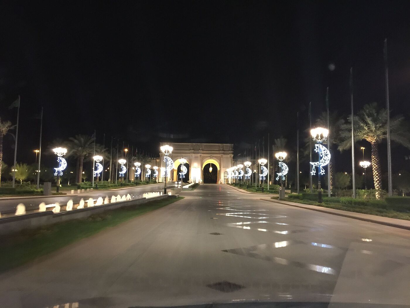 The grand illuminated entrance driveway to the Ritz-Carlton hotel in Riyadh at night