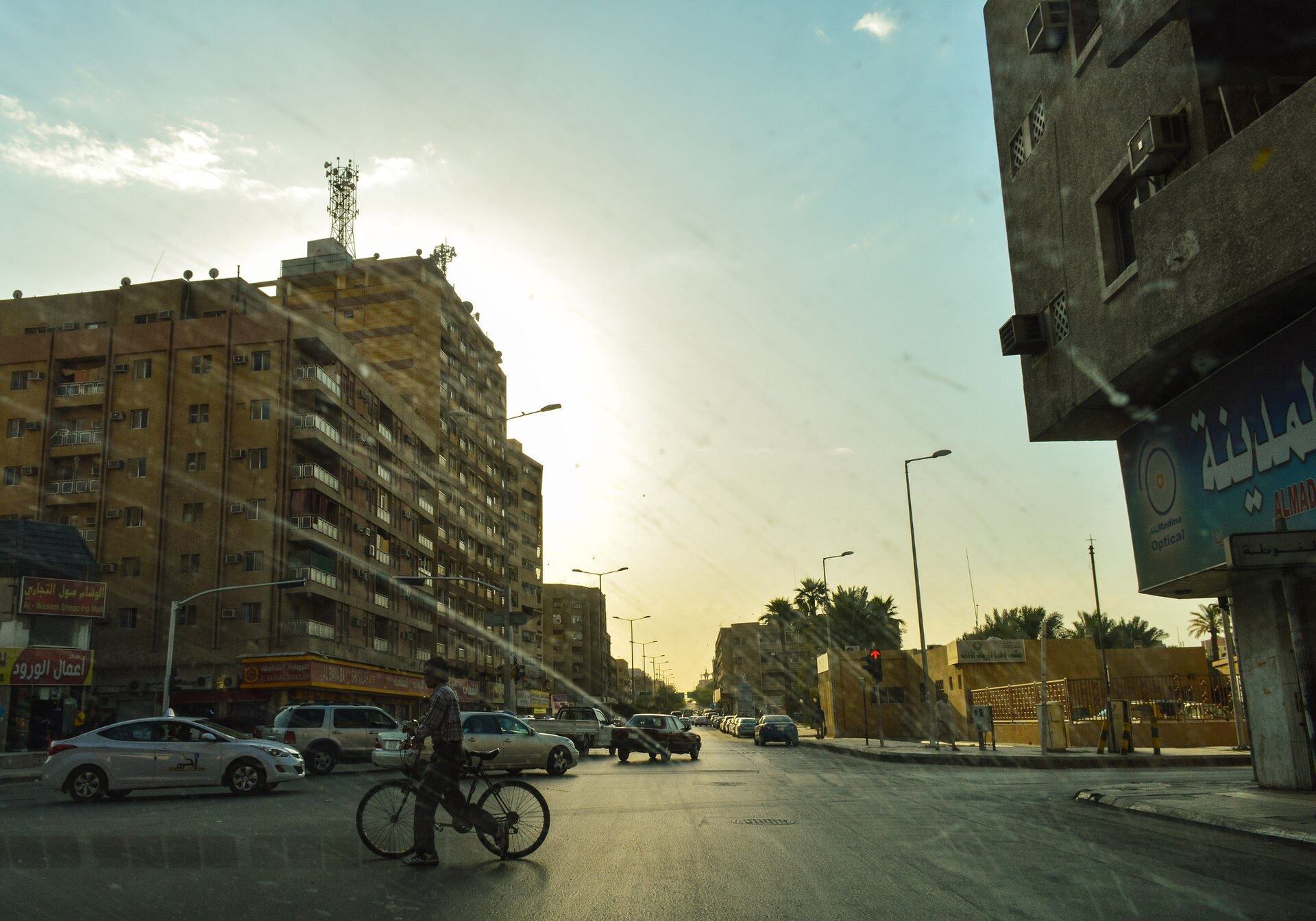 Downtown Riyadh street scene with cars and buildings at sunset