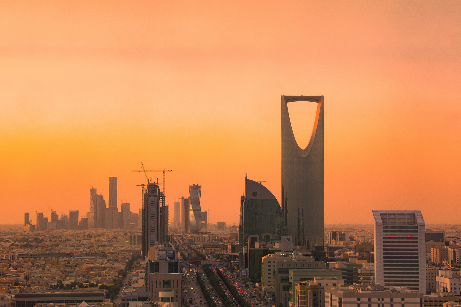 Riyadh skyline at sunset showing the King Abdullah Financial District towers under construction and the Kingdom Tower, Saudi Arabia.