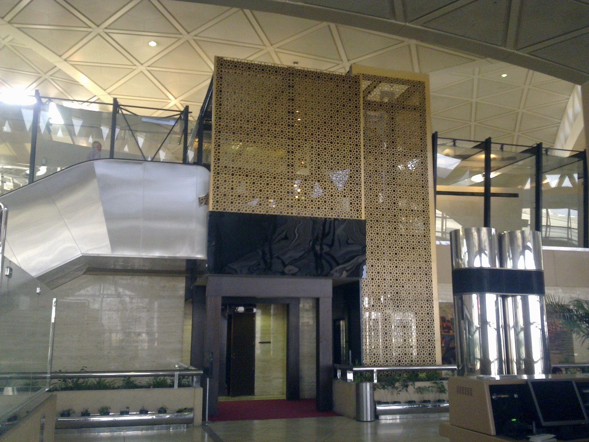 Interior of King Khalid International Airport in Riyadh showing Islamic geometric design elements and escalators
