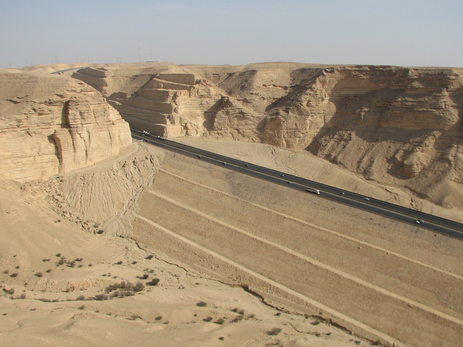 The Riyadh-Makkah highway cutting through the dramatic Tuwaiq Escarpment with desert landscape