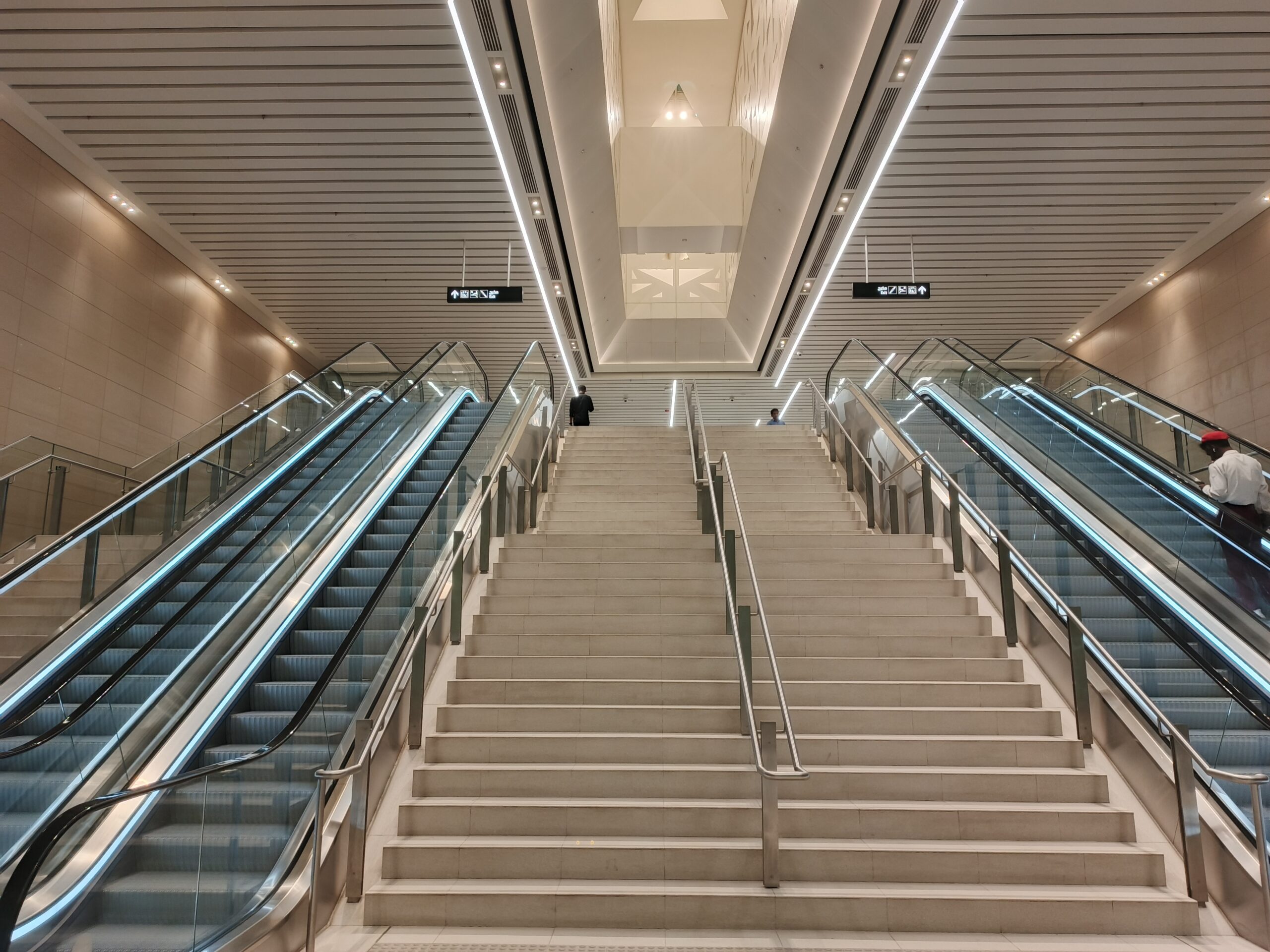 Interior of a Riyadh Metro station showing modern escalators and staircase with clean architectural design