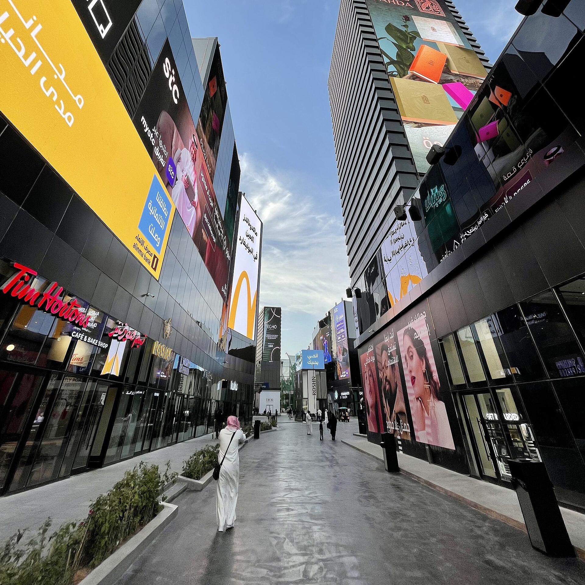 Boulevard City walkway in Riyadh with restaurants, screens, and visitors during Riyadh Season