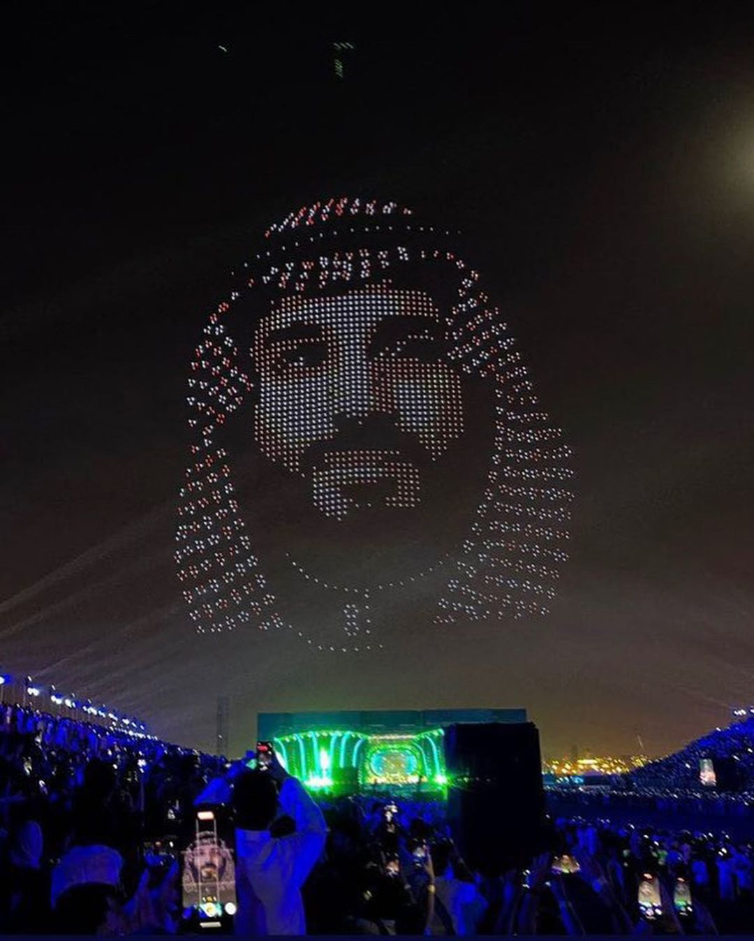 Spectacular drone light show forming a portrait in the night sky above a crowd at a Riyadh Season entertainment event
