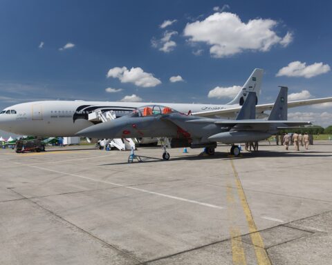 Royal Saudi Air Force F-15SA fighter jet on the tarmac alongside an RSAF A330 MRTT tanker aircraft, showing Saudi Air Force markings and Arabic inscriptions