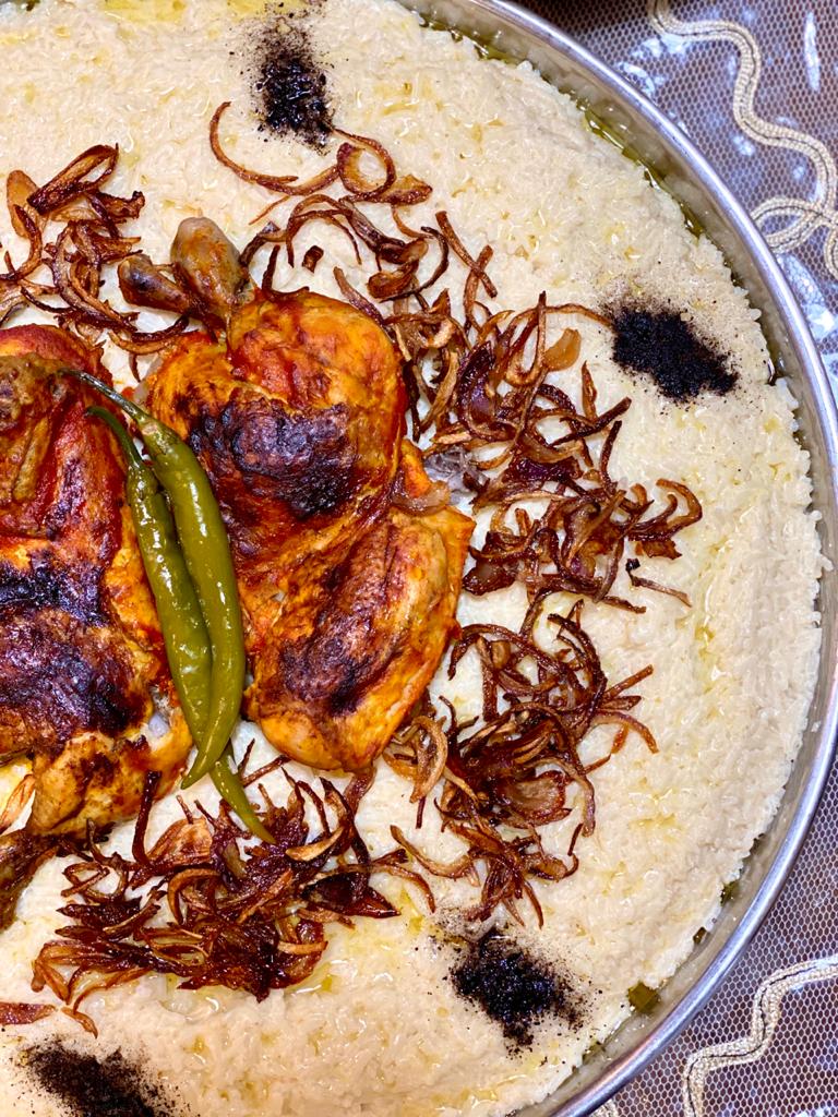 Saleeg — Hijazi white rice cooked in broth and milk, topped with roasted chicken