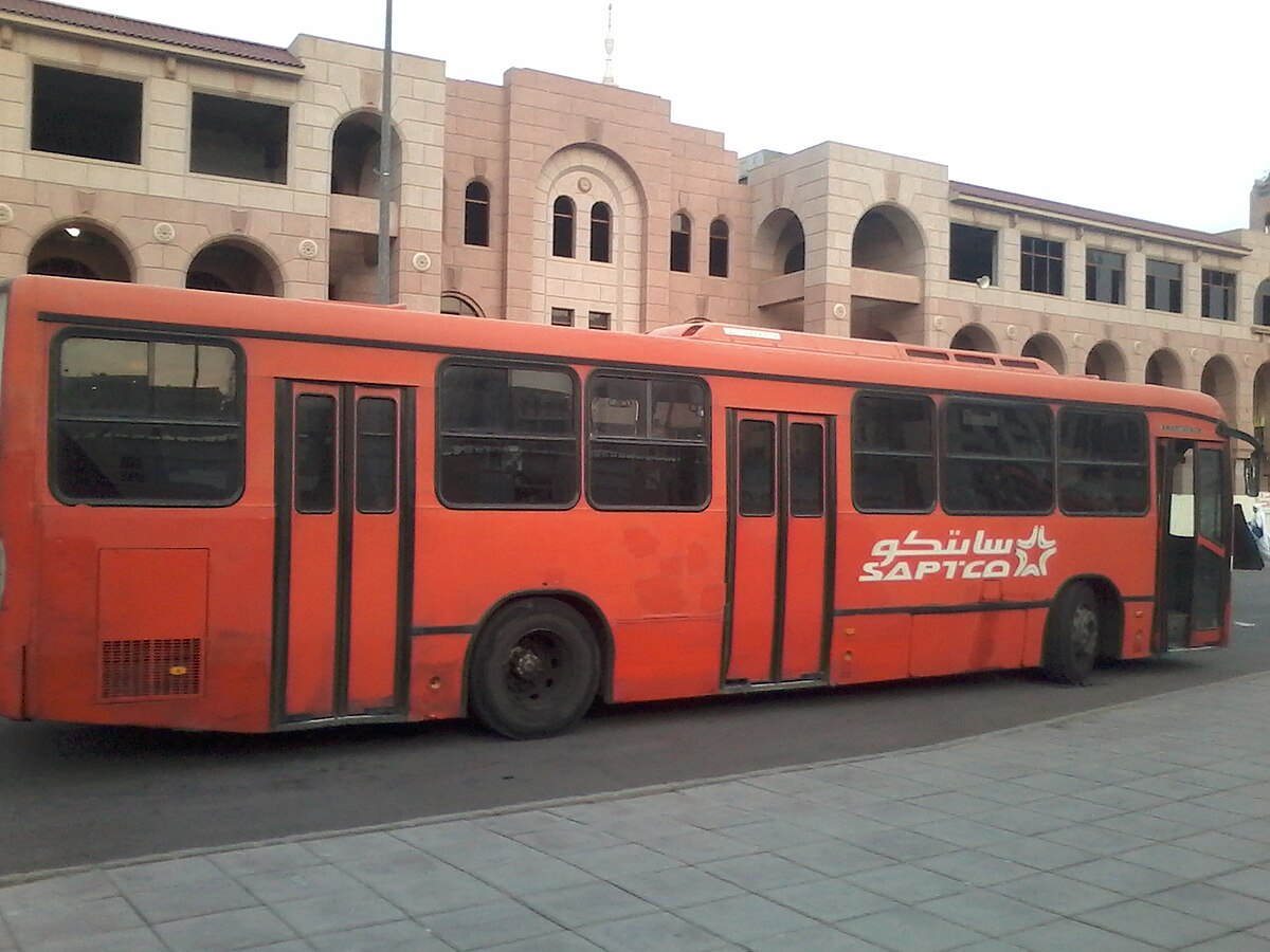 Orange SAPTCO city bus on an urban route in Madinah