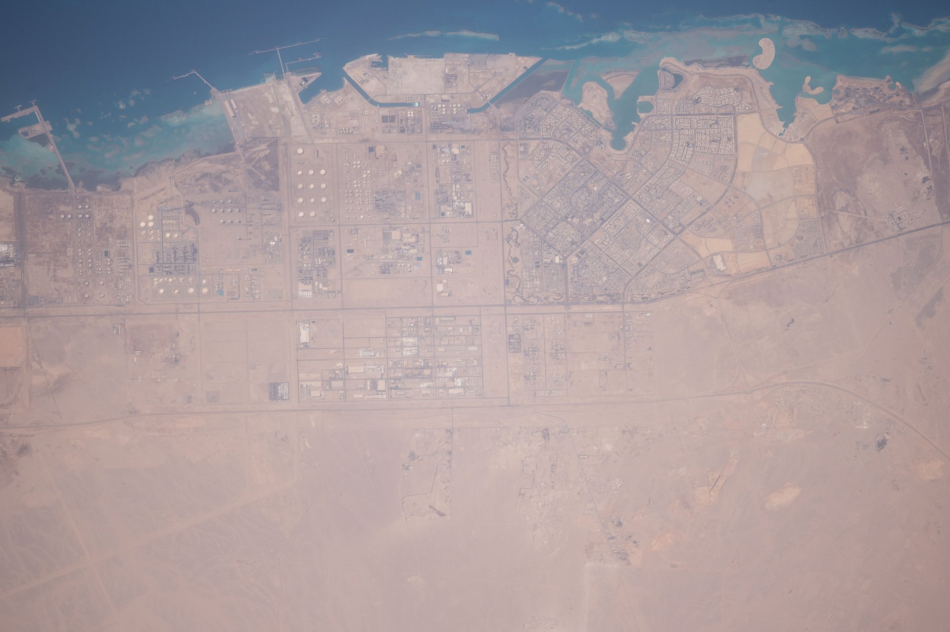 Saudi Arabia Eastern Province industrial coastline photographed from the International Space Station — the Jubail and Dammam zone absorbed 11 ballistic missiles and 18 drones in a single April 7 barrage