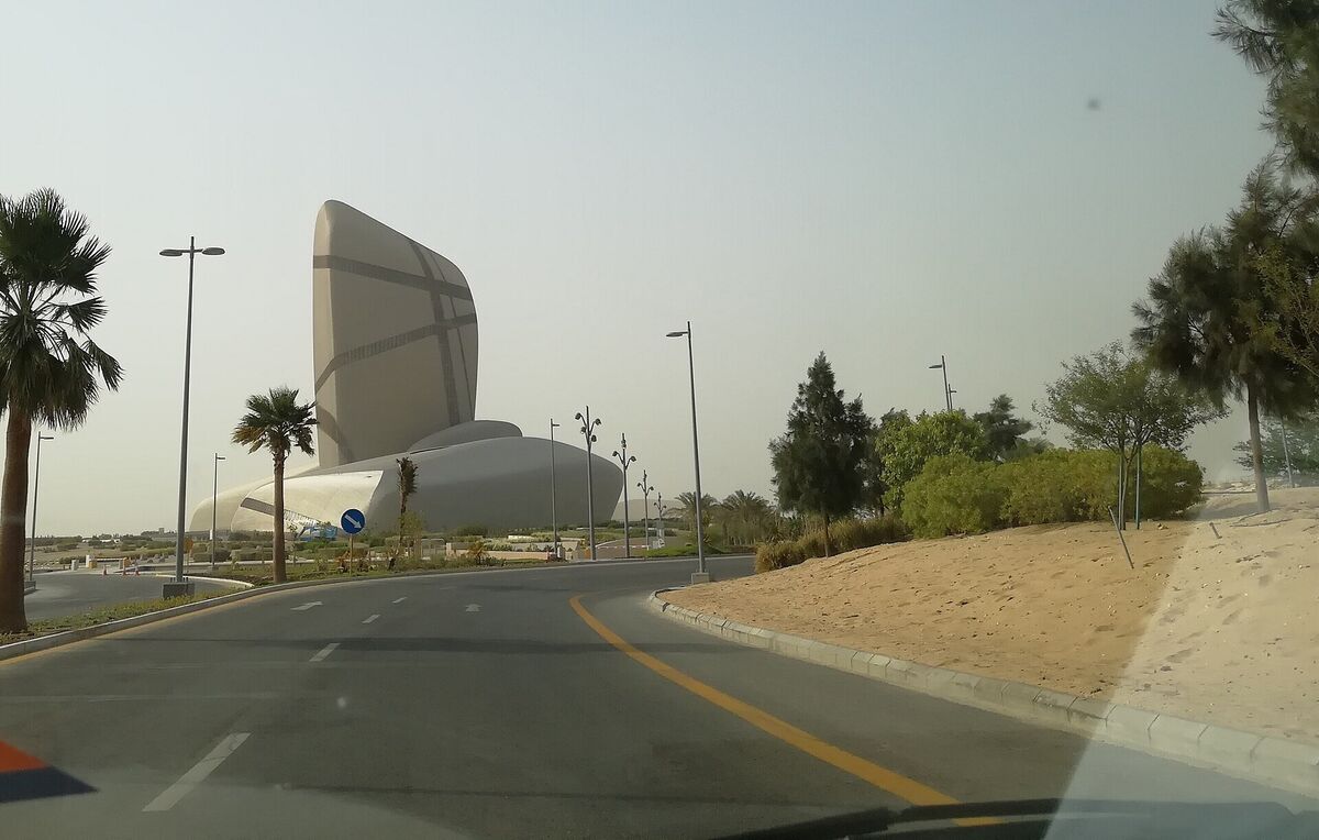 Exterior view of the King Abdulaziz Center for World Culture (Ithra) in Dhahran, Saudi Arabia, showing the building's curved metallic facade