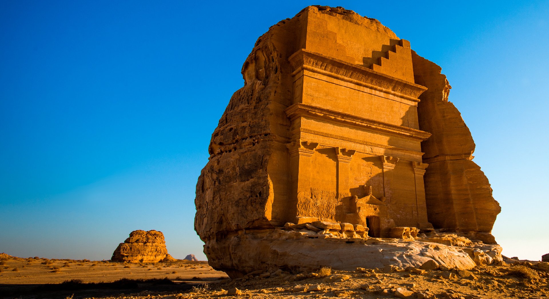 Nabataean tomb at Hegra near AlUla in golden desert light
