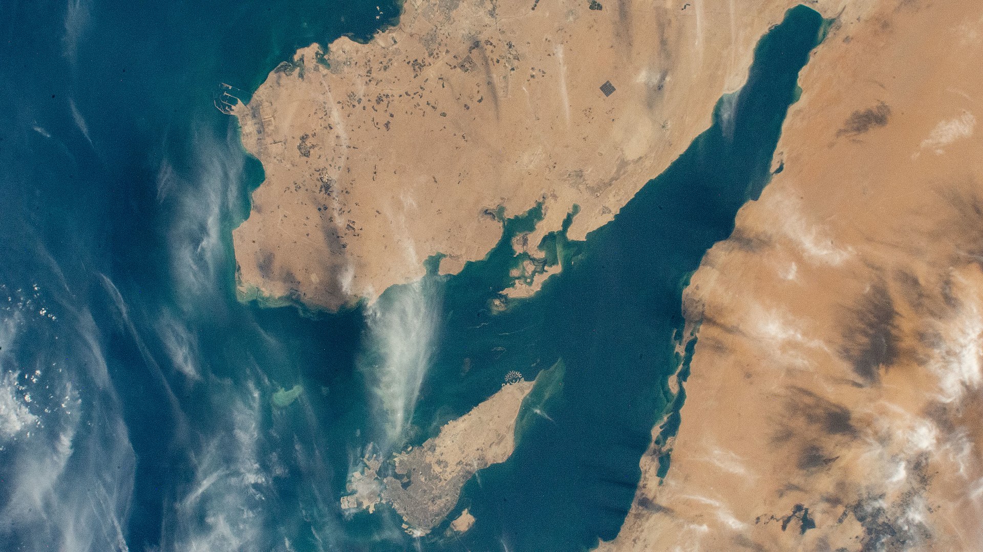 Qatar peninsula (top left), Bahrain island (bottom left), and the Eastern Province coast of Saudi Arabia (right) photographed from the International Space Station. Jubail Industrial City and Ras Tanura lie 65-73 kilometres apart along this coastline — a gap too large for a single PAC-3 Patriot battery to cover simultaneously.