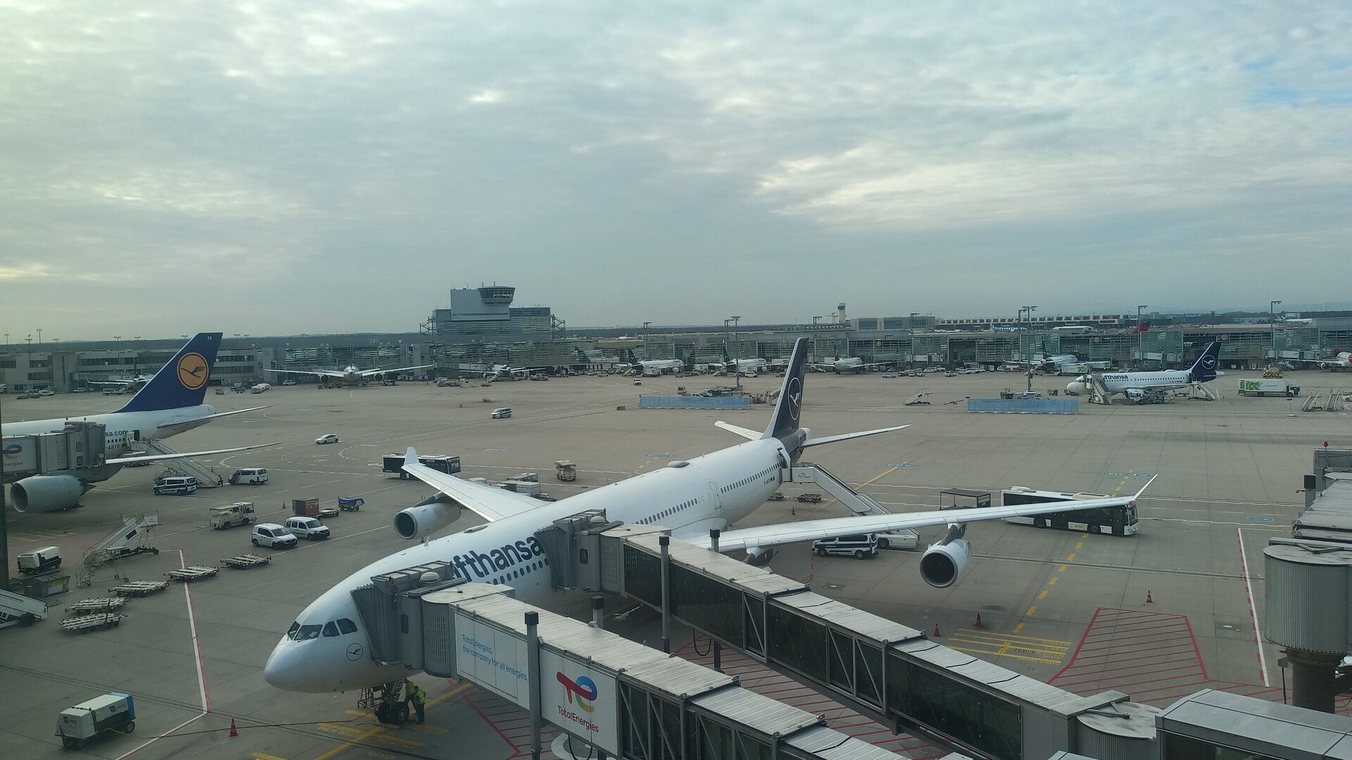 Lufthansa aircraft at Frankfurt Airport terminal with jet bridges connected