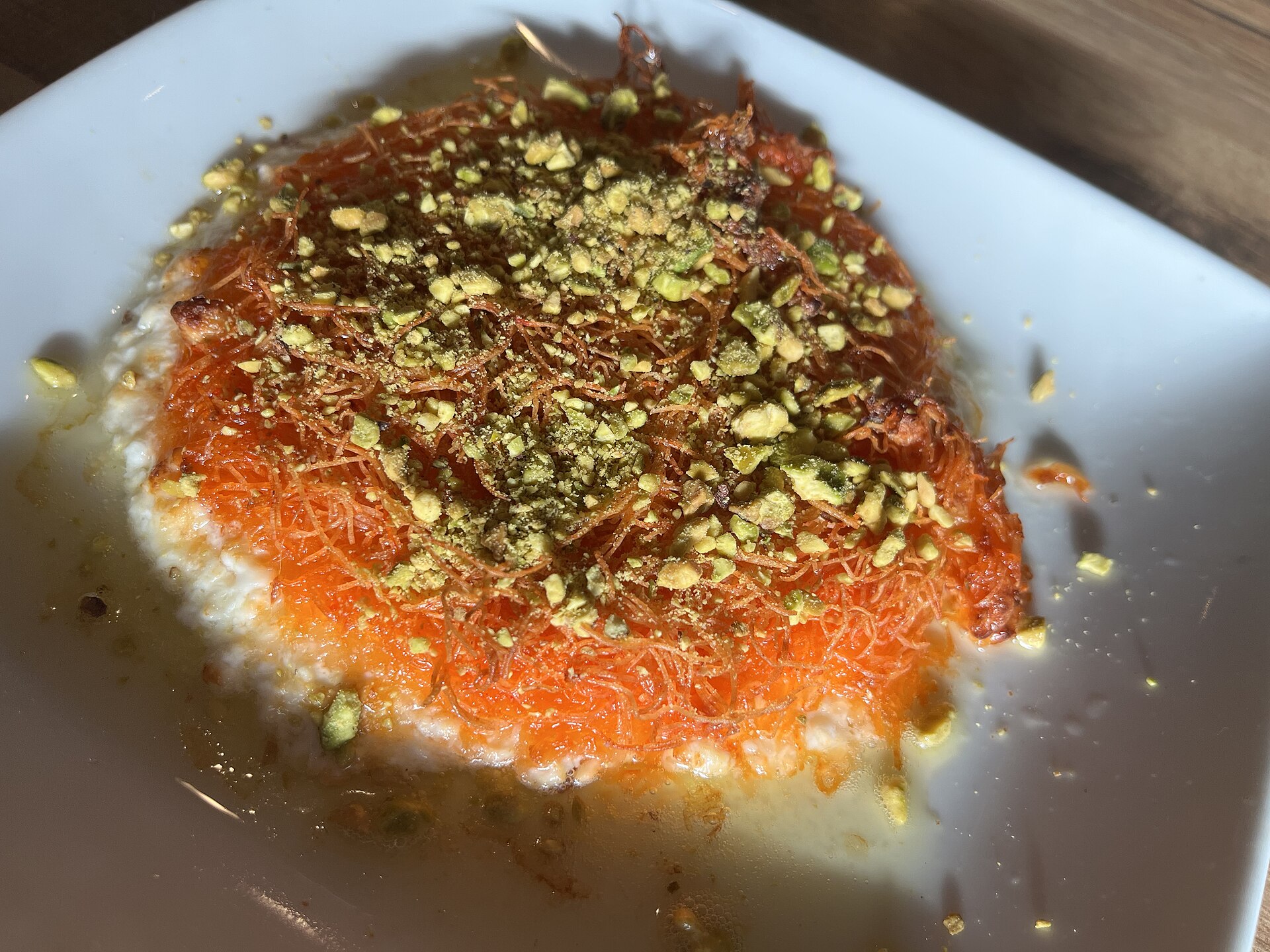 Kunafa pastry with cheese filling topped with crushed pistachios