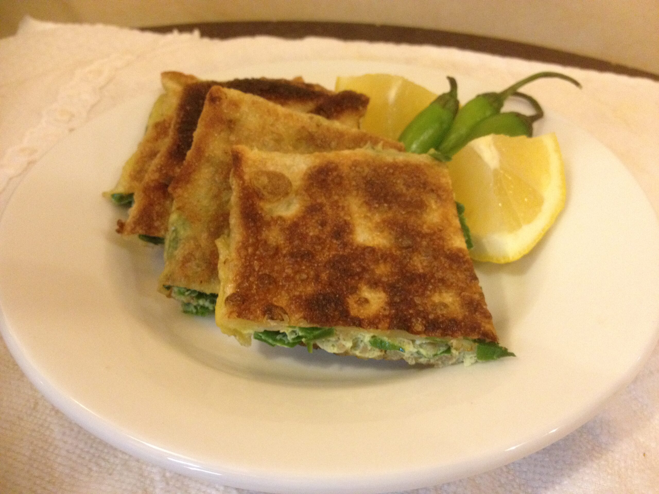 Saudi mutabbaq stuffed flatbread with lemon and green chillies