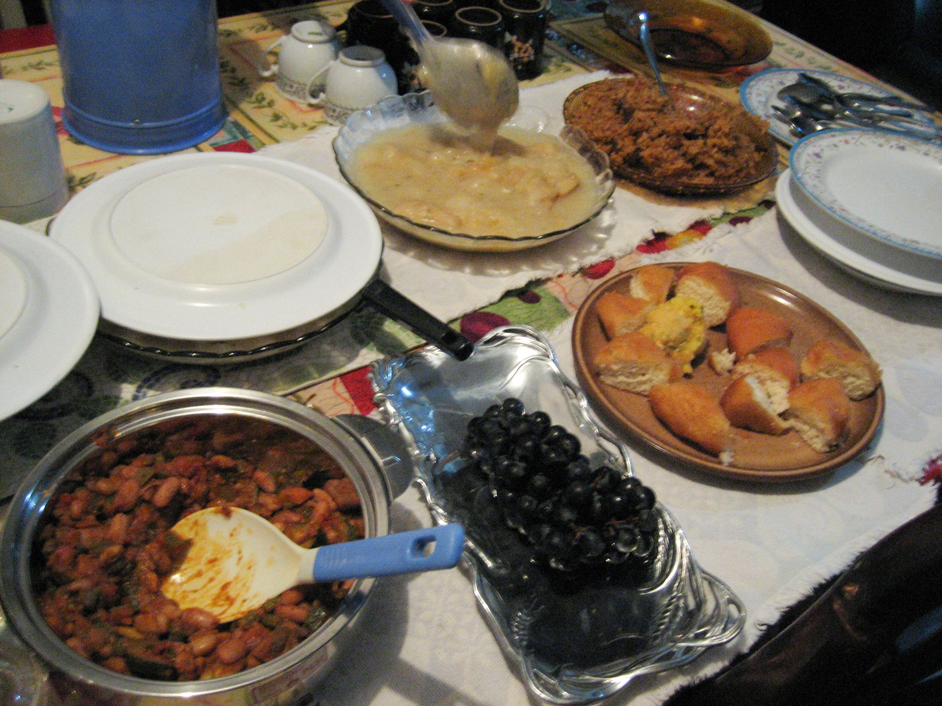 An iftar dinner spread with traditional dishes laid out on a communal table during Ramadan