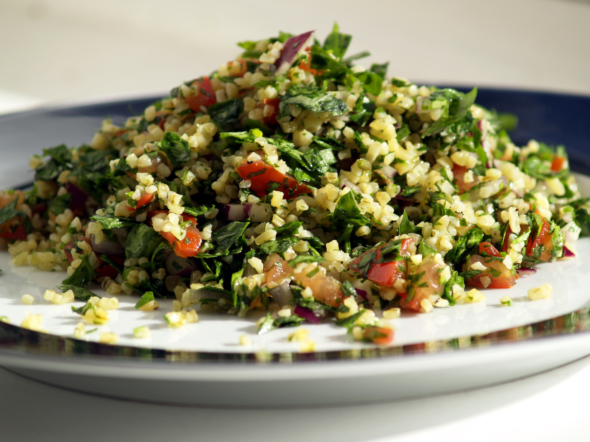 Tabbouleh salad made with parsley, bulgur wheat, tomatoes, and lemon dressing