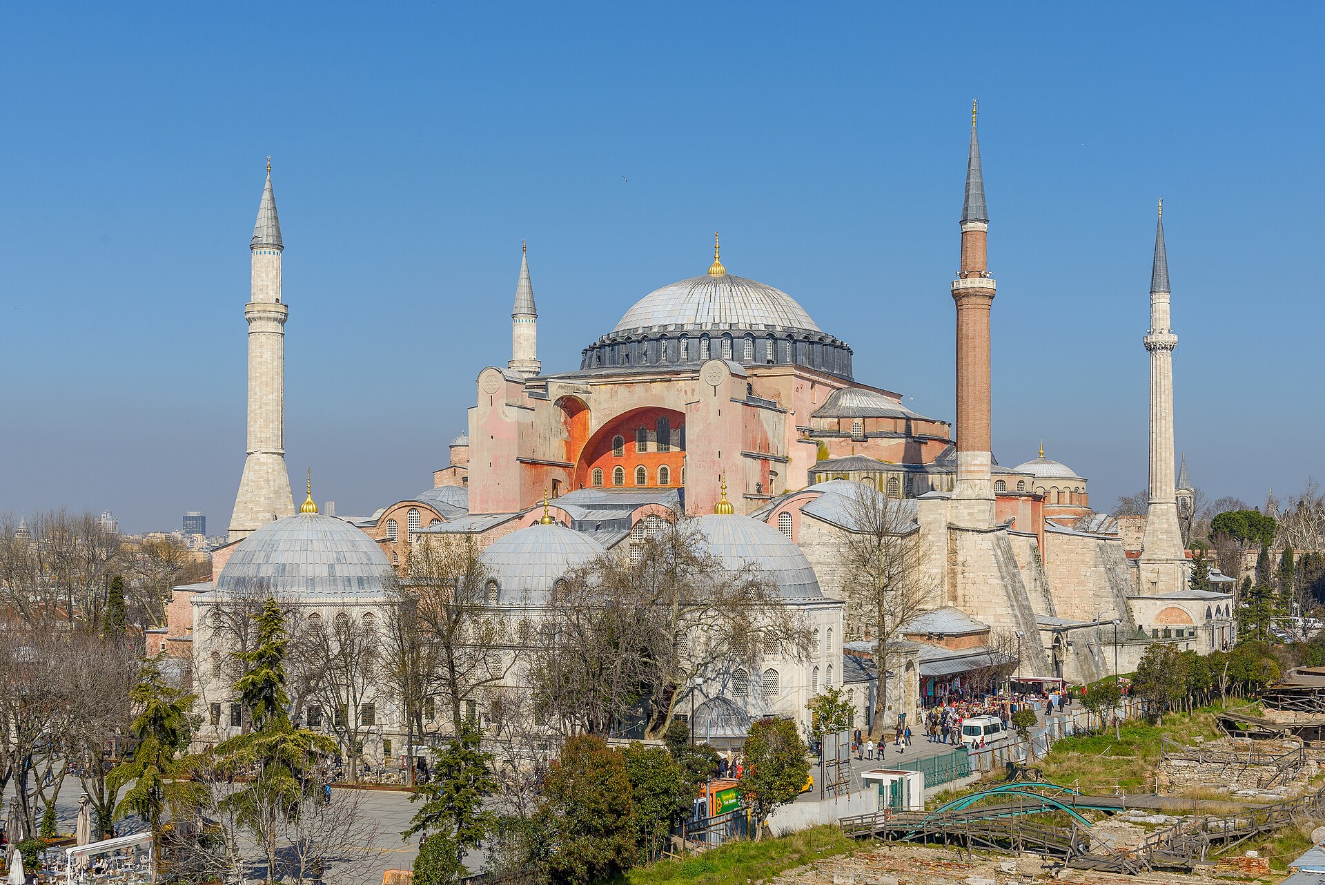 Hagia Sophia in Istanbul, showing its massive dome and four minarets, with the surrounding grounds and gardens visible in the foreground
