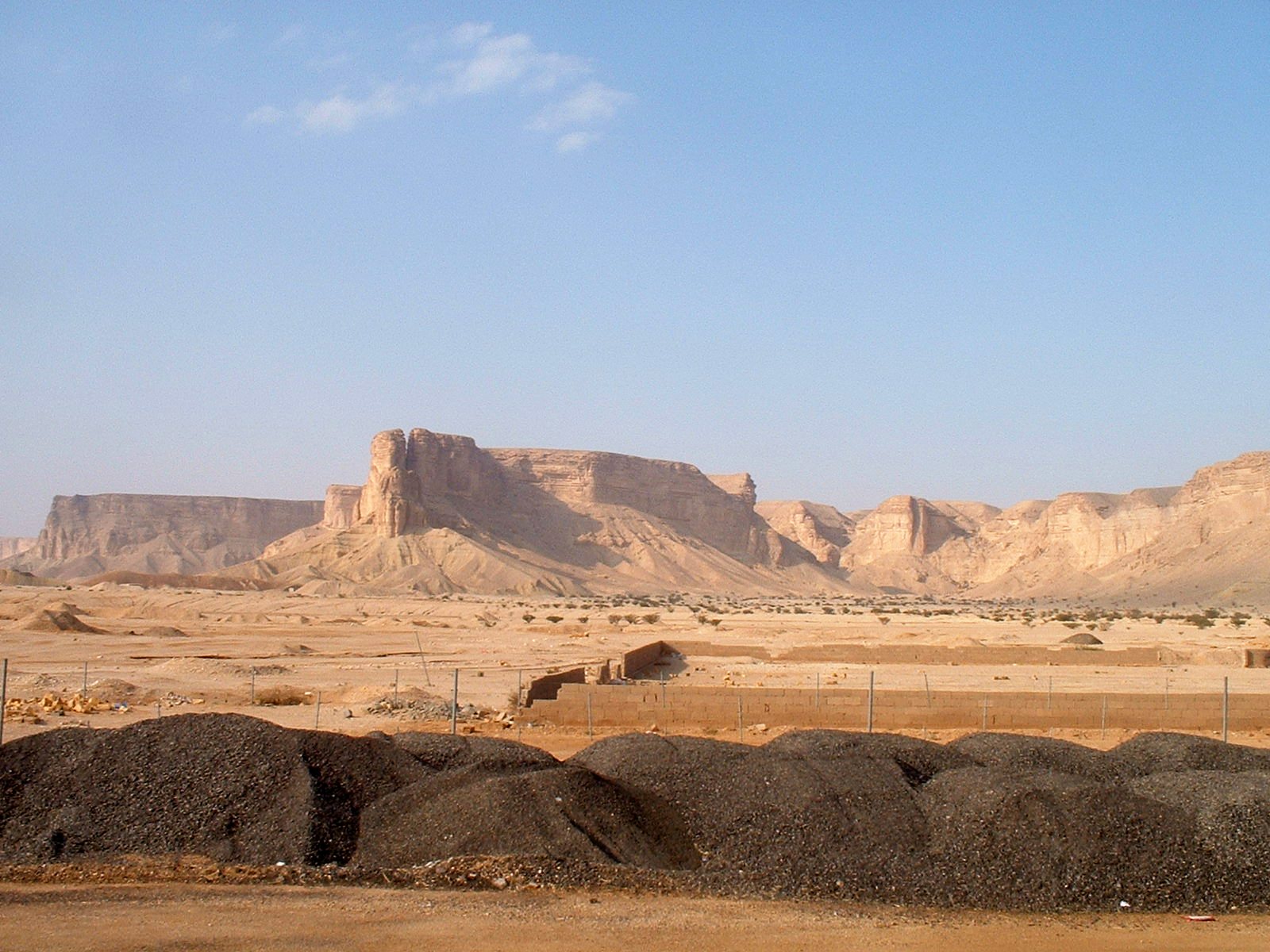 The dramatic Tuwaiq Escarpment cliff face near Riyadh, known as the Edge of the World, overlooking a vast desert plain