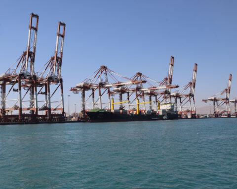 Shahid Rajaei port container cranes and cargo ship at Bandar Abbas, Iran — the port handles 85-90% of Iran's container traffic