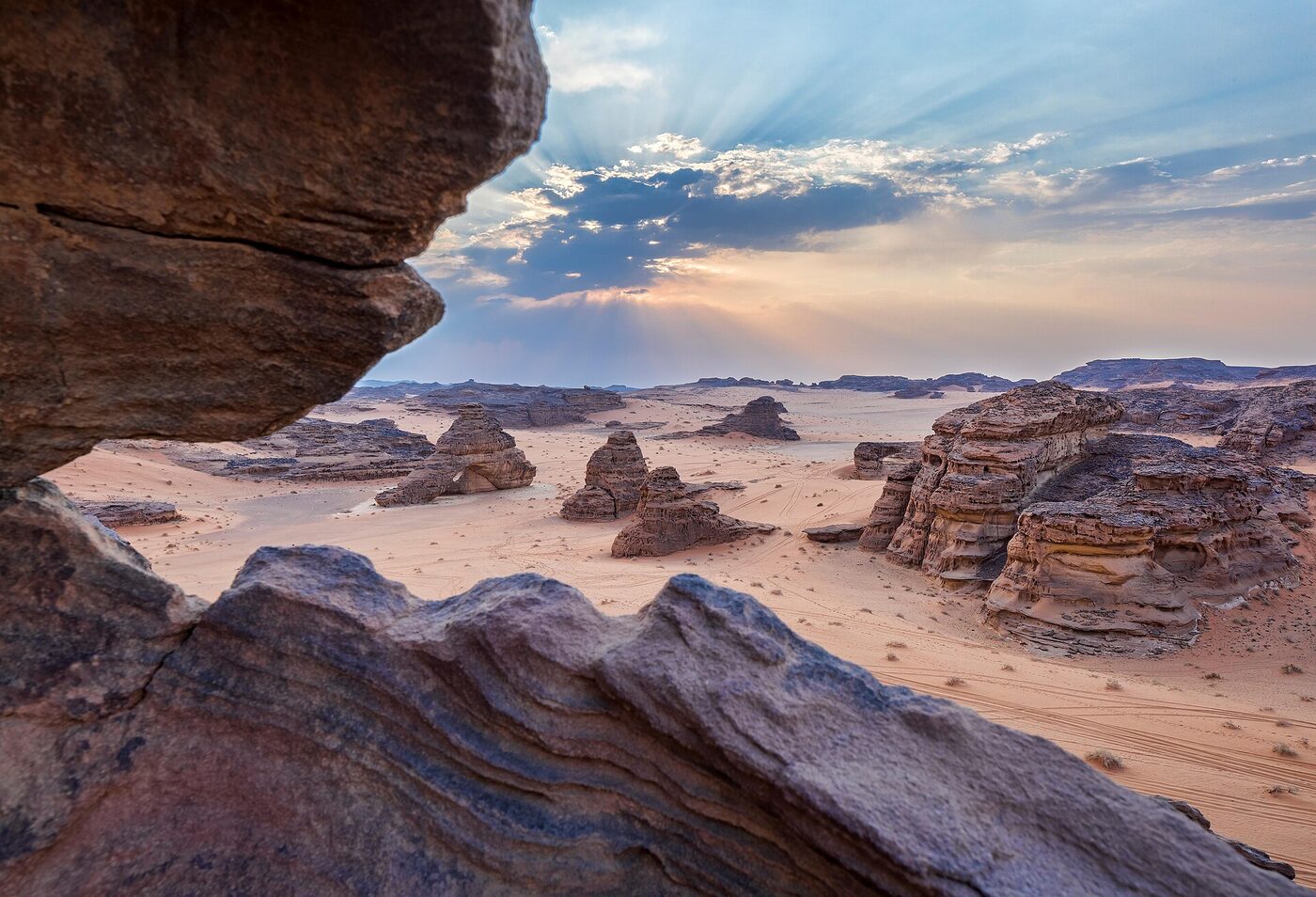 Layered sandstone rock formations in Sharaan Nature Reserve, AlUla, Saudi Arabia at sunset