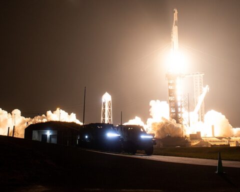 SpaceX Falcon 9 rocket launching NASA Crew-6 mission with long-exposure light trail against night sky at Kennedy Space Center