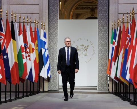 British Prime Minister Keir Starmer walks through the Palais de la République at the Coalition of the Willing summit hosted by French President Emmanuel Macron at the Élysée Palace, January 2026 — the same bilateral European coalition framework that convened again in April 2026 on Hormuz maritime freedom of navigation