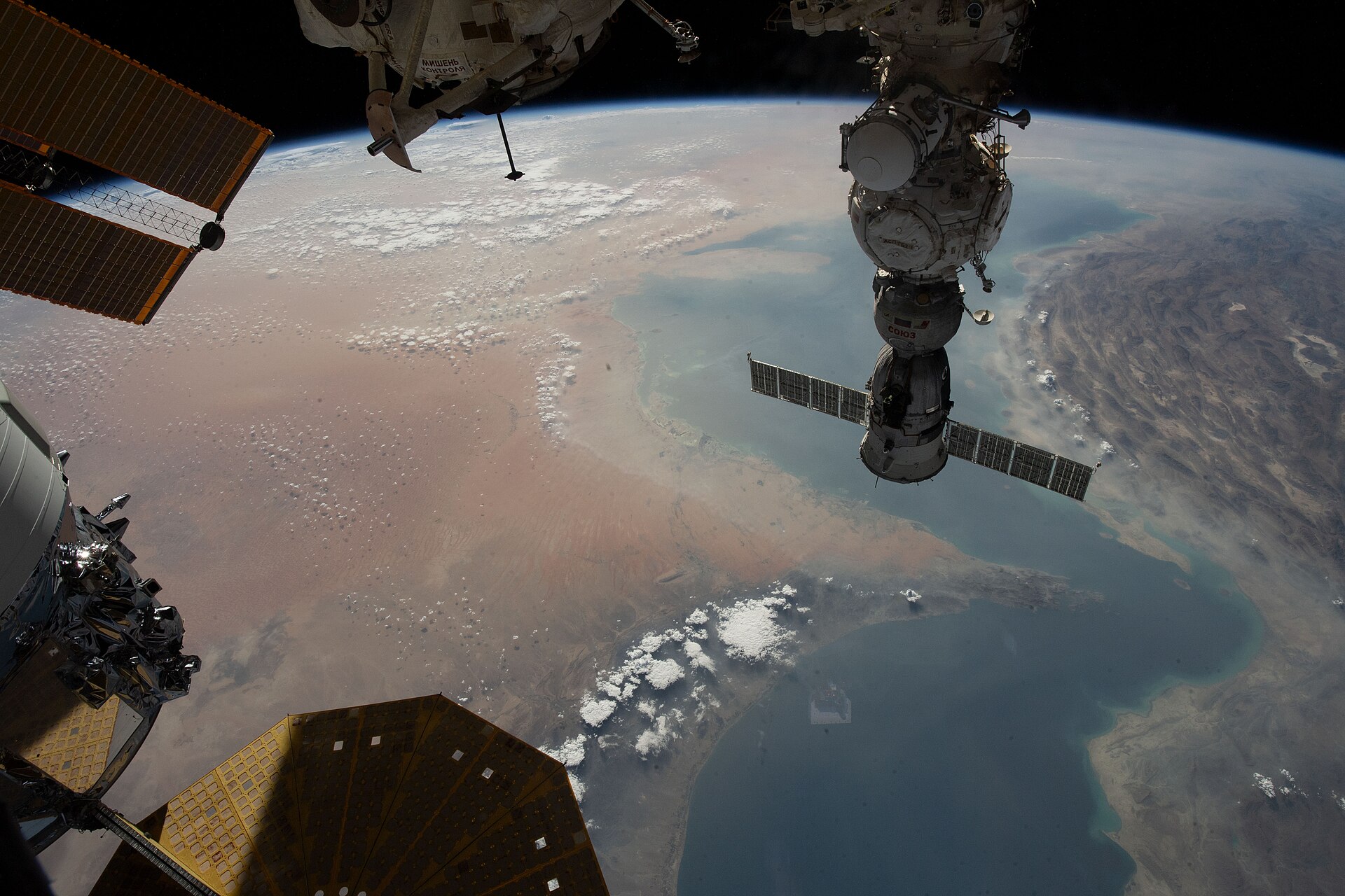 The Strait of Hormuz and Persian Gulf photographed from the International Space Station at 262 miles altitude, August 2023, showing the 21-mile-wide chokepoint connecting the Gulf of Oman with the Persian Gulf