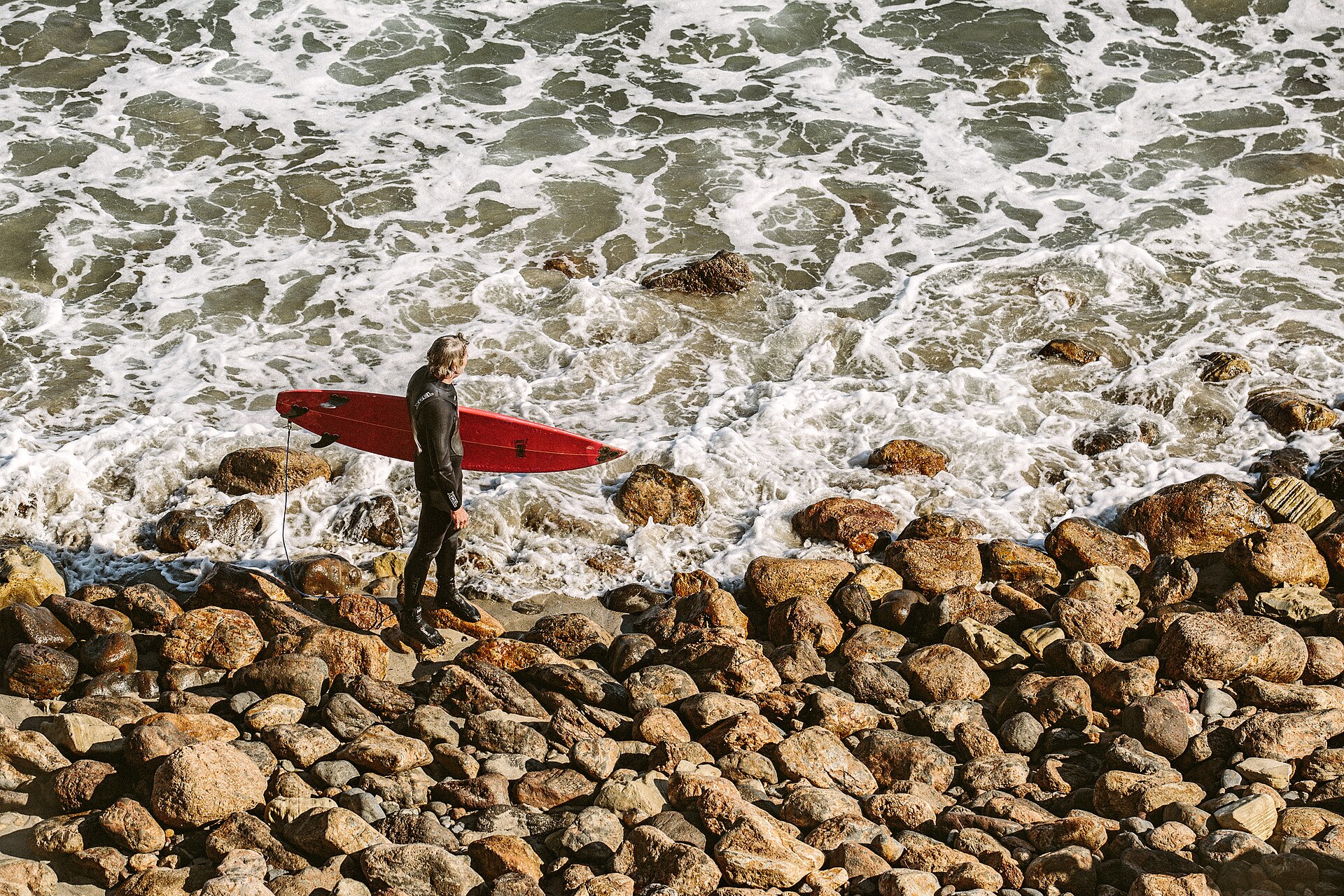 Surfer assessing ocean wave conditions