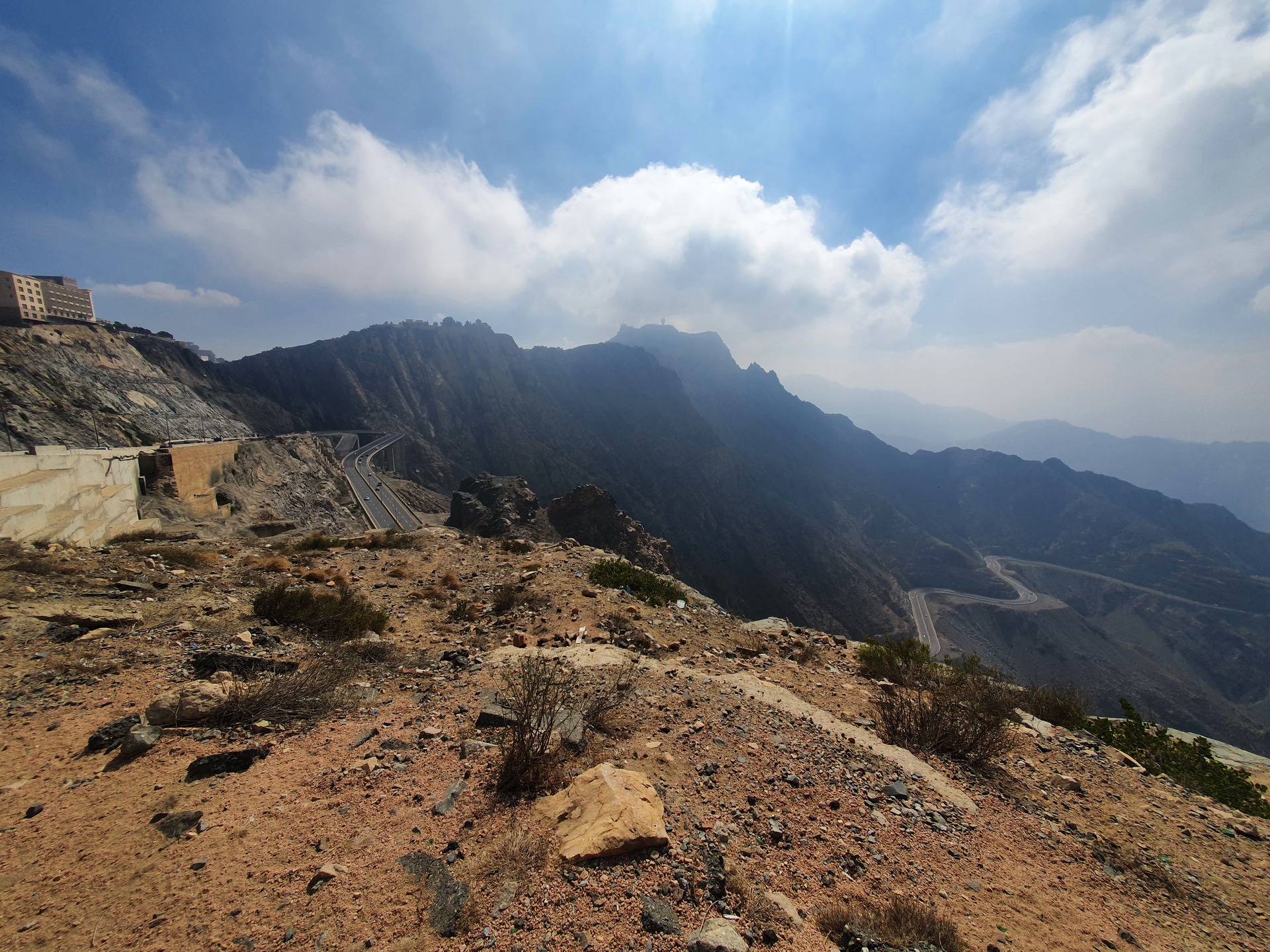Panoramic mountain landscape near Al Hada, Taif, showing the rugged Hejaz escarpment under cloudy skies