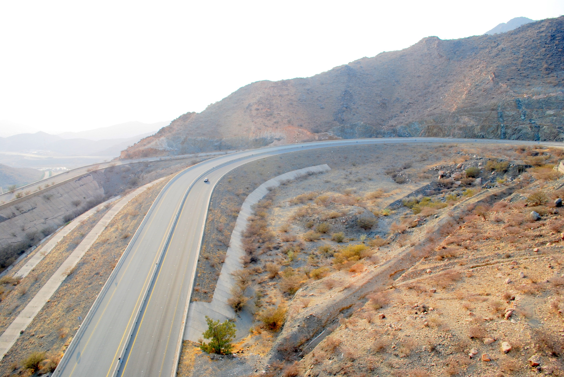 Aerial view of Taif's mountain road from the Al Hada cable car showing the winding highway through the Hejaz escarpment