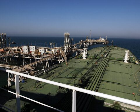 Crude oil tanker docked at the Al Basrah Oil Terminal in the Persian Gulf, loading cargo from an offshore platform