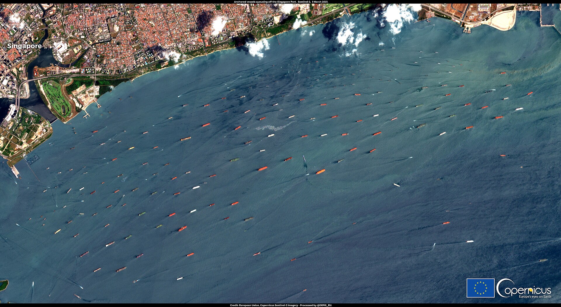 Copernicus Sentinel-2 satellite image showing dozens of vessels anchored and queuing at sea, illustrating the scale of shipping disruptions from Hormuz mine closure