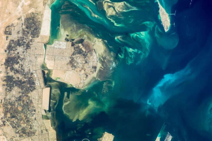ISS photograph of Tarout Bay, Saudi Arabia, showing Ras Tanura oil terminal peninsula and tanker berths from orbit. Photo: NASA / Public Domain
