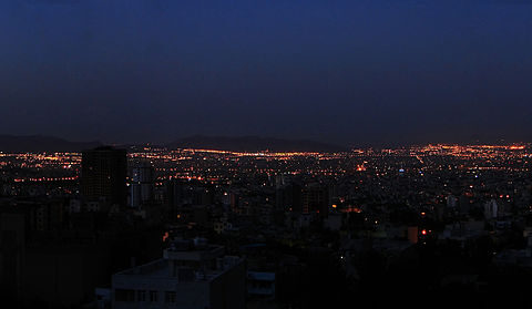 Tehran panorama at dawn with city lights and moon, April 2026 deadline day