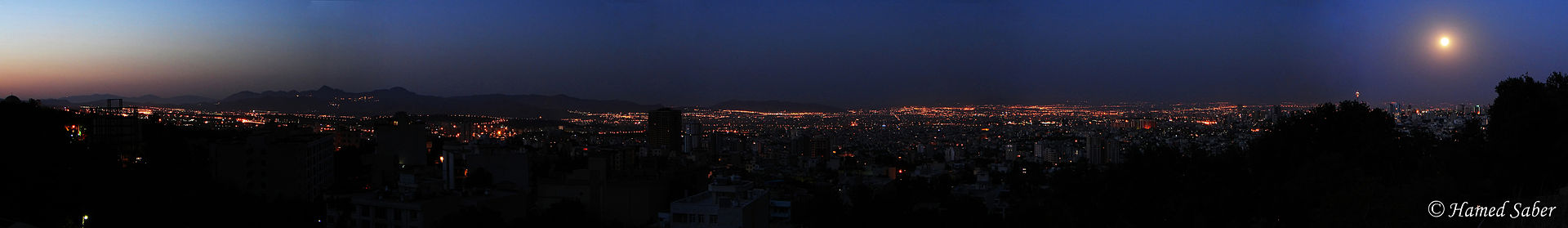 Tehran panorama at dawn with city lights and moon, April 2026 deadline day