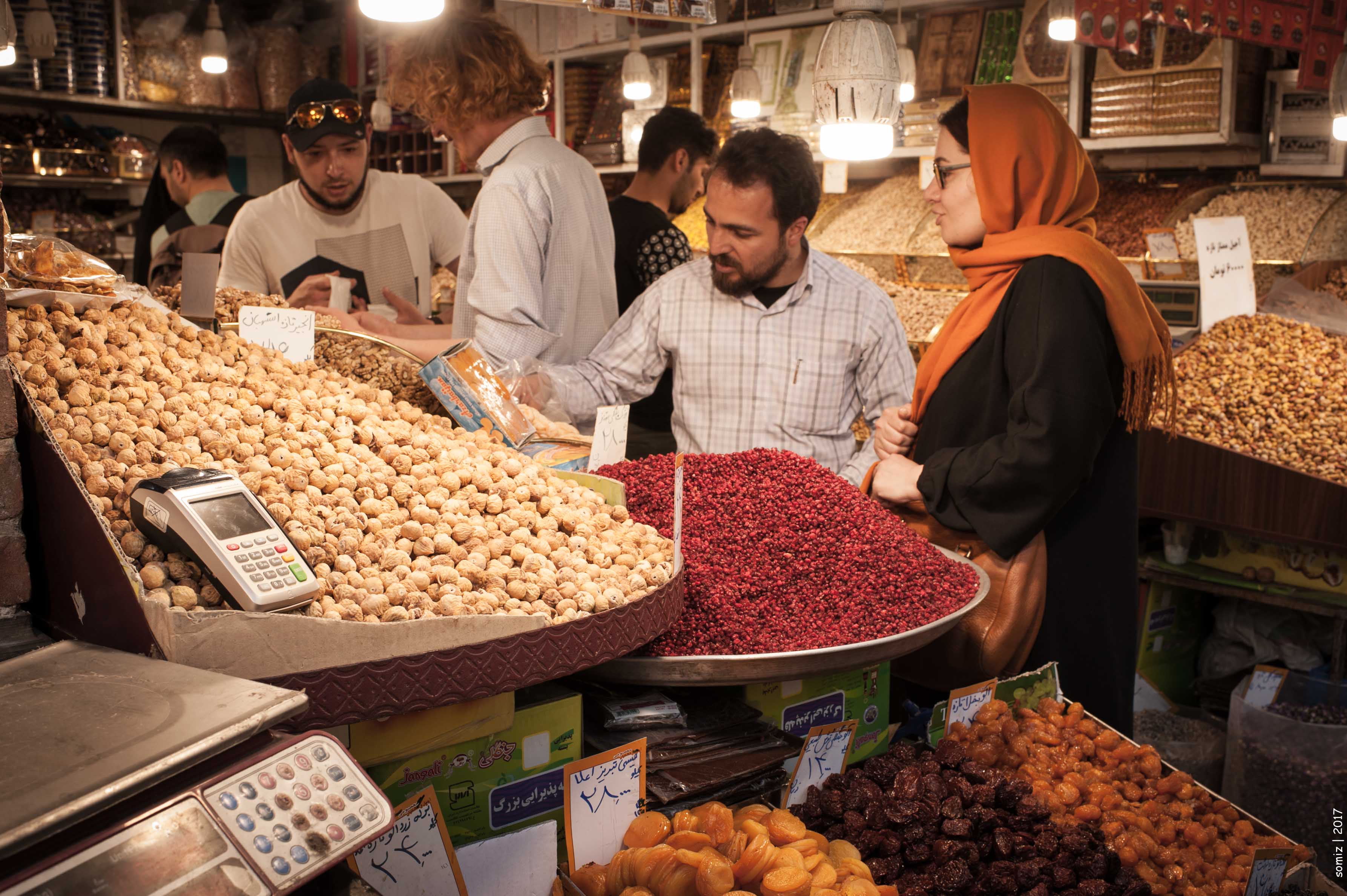 A vendor serves customers at a food stall in a Tehran market — food prices more than 50 percent above pre-war levels as Iran economic collapse accelerates