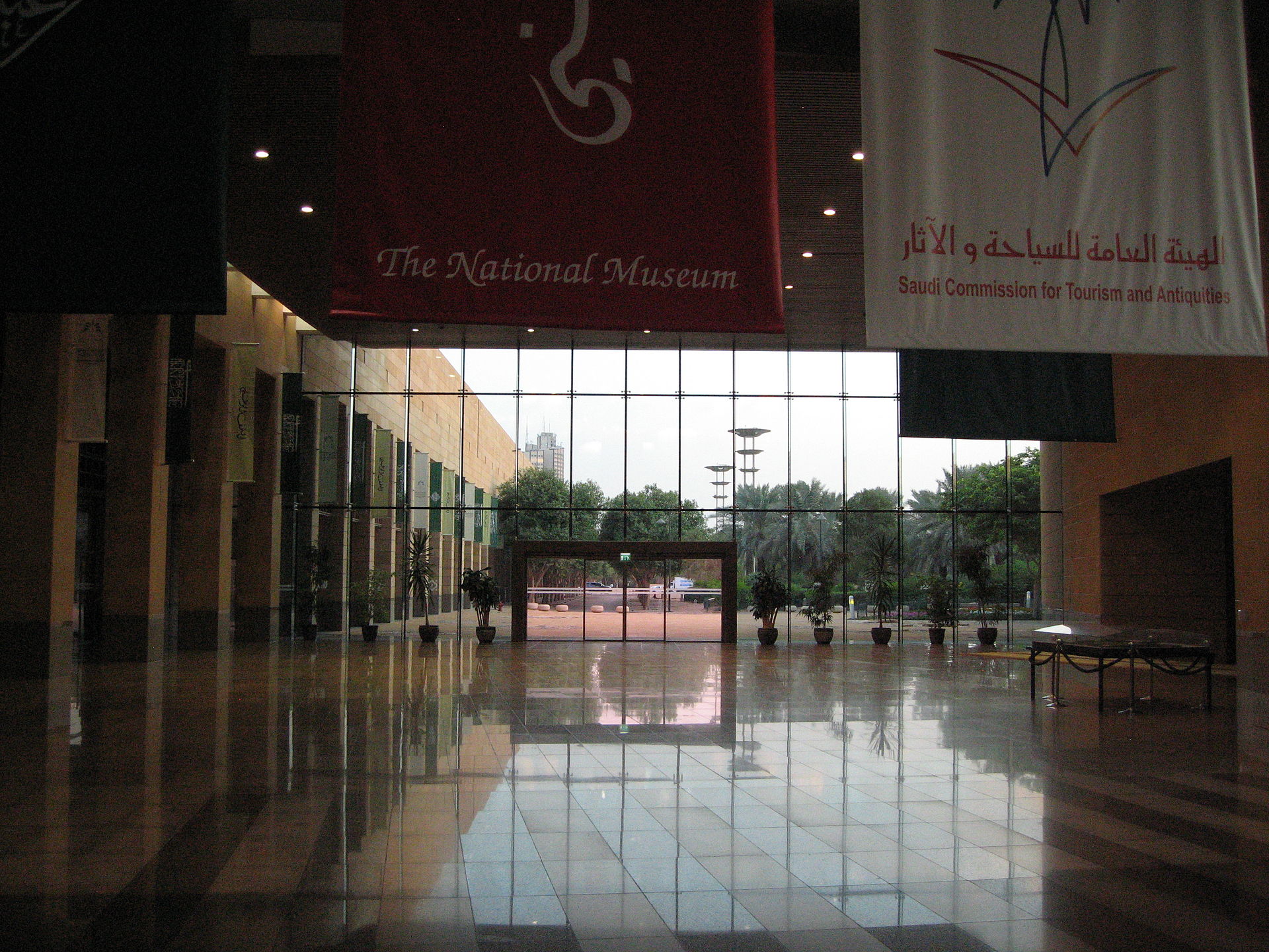 The grand lobby of the National Museum of Saudi Arabia in Riyadh, with banners and floor-to-ceiling glass walls