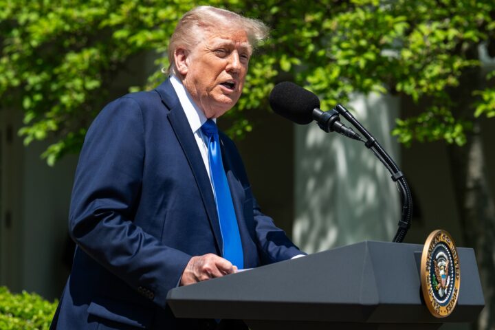 President Trump speaking at White House podium with presidential seal, May 2025